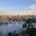 A panoramic view of a city featuring the river, historic buildings, and a clear sky.